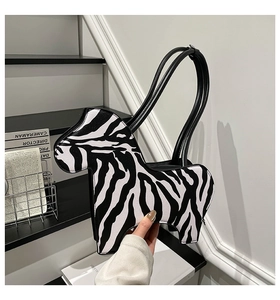 Detailed view of the zebra pattern texture on the pony-shaped PU leather shoulder bag