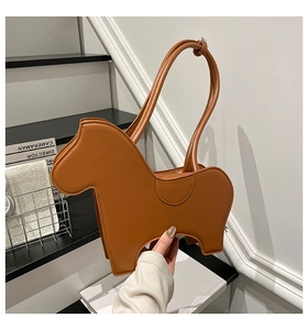 Close-up of caramel brown Trojan horse shaped PU leather shoulder bag with smooth texture