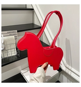 Detailed view of red pony-shaped handbag with smooth leather finish and zipper closure