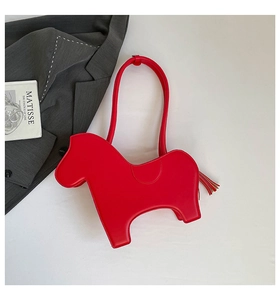 Detail of red horse-shaped PU leather shoulder bag with fringe tassel tail and thin strap