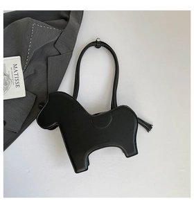 Detailed view of the horse-shaped black PU leather bag with tassel and saddle stitching