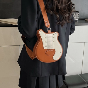 Guitar shaped crossbody bag in brown and white PU leather with studded details