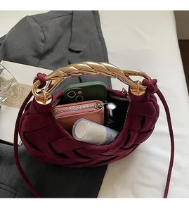 Interior view showing the large capacity of the woven burgundy crescent handbag