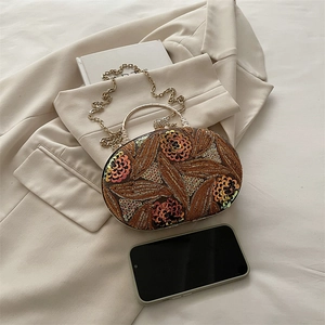 Bolso de noche ovalado con lentejuelas, bordado floral y asa metálica dorada