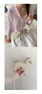 Detail of handmade pearl woven horse bag with silver mane accents and fine chain