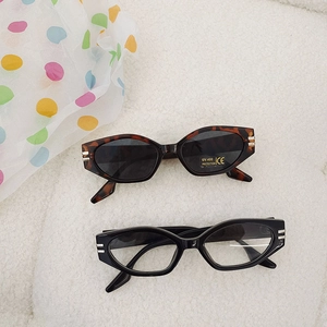 Kids vintage small frame cat eye sunglasses with UV400 protection on white soft rug