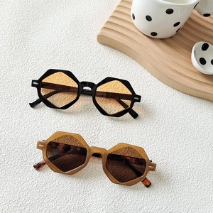 Retro polygon sunglasses in black with orange lenses and classic tortoiseshell finish