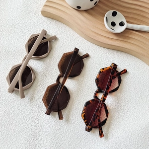 Retro polygonal sunglasses in beige, translucent brown, and tortoise shell frames