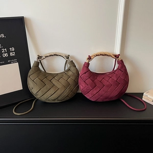 Fashionable woven crescent handbag in olive green and burgundy with metallic handles