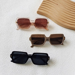 Three pairs of stylish square frame sunglasses in tea, matte coffee, and black tones