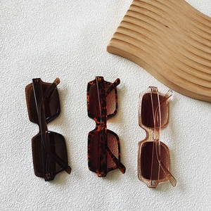 Square oversized sunglasses in dark brown, tortoiseshell, and transparent champagne frames