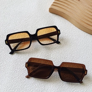 Close-up of square sunglasses frames with metal rivets and temple size specifications