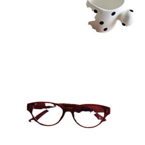 Chic dark red oval cat eye sunglasses with metal accents on a minimalist white background