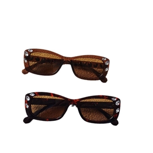 Retro oval tortoiseshell sunglasses for women and men with rhinestone accents on white background