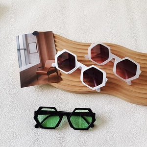 Three pairs of oversized hexagonal sunglasses with colorful frames and gradient lenses