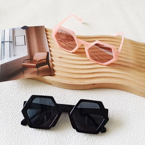 Chic oversized hexagonal sunglasses in black and pink frames with bold retro style