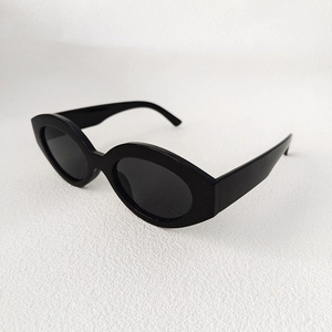 Detailed side view of glossy black vintage cat-eye sunglasses with thick plastic frames