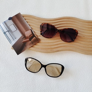 Fashionable oversized rectangular sunglasses in tortoise shell and black on aesthetic board