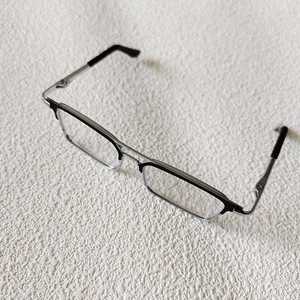 Detailed view of 20cm doll glasses featuring silver metal temples and black half-rim frames