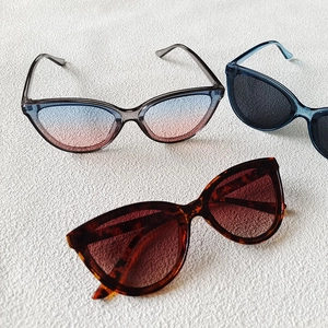Three pairs of oversized cat eye sunglasses in gradient and tortoiseshell frames