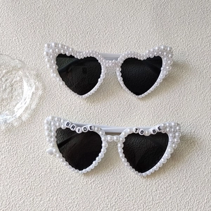 Detail of heart bridal sunglasses with white pearls and Bride To Be letter beads