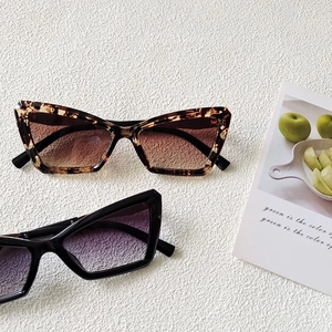 Retro cat-eye sunglasses set in tortoiseshell and black frames with gradient lenses