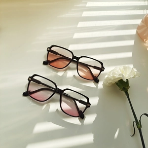 Close-up of trendy oversized sunglasses with gradient lenses and stylish black frames