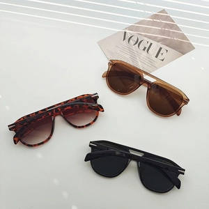 Detailed view of trendy oversized sunglasses in leopard, tea, and matte black finishes