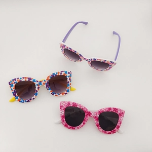 Detailed view of kids floral sunglasses in white and pink frames with colorful patterns