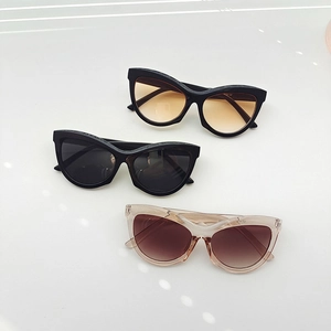 Retro triangle cat-eye sunglasses set in black and champagne frames with gradient lenses