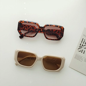 Flat lay of leopard print and cream square frame sunglasses with gradient lenses