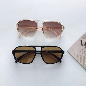 Retro double-bridge pilot sunglasses in classic black and pink frames with gradient lenses