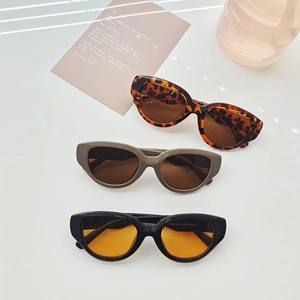 Futuristic cat-eye sunglasses in leopard print, taupe and black with colored lenses