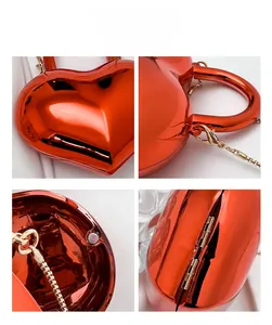 Detail view of red heart acrylic mini bag with mirror finish and gold chain strap