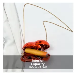 Internal capacity of red heart-shaped acrylic chain bag showing space for a lipstick