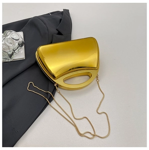 Detailed view of glossy gold acrylic evening box bag with hollow oval handle and chain