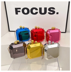 Collection of geometric acrylic clutch bags in metallic colors with chain straps