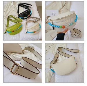 Detail of lychee textured crescent chest bag with woven strap and acrylic chain