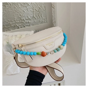 Detail of off-white lychee leather chest bag with colorful bead chain and adjustable strap