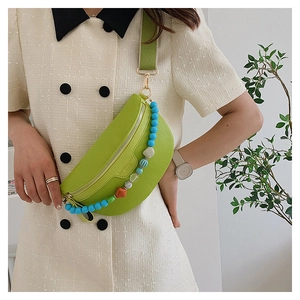 Detail of lime green pebble leather chest bag with colorful beads and wide strap