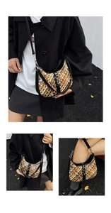 Close-up of woven checkered texture and adjustable leather strap on a crescent bag