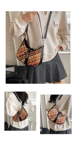 Detail of multi-color woven crossbody bag with black trim and silver metal lock clasp