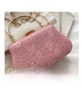 Detail of pink floral lace evening bag featuring sparkling sequins and a gold round handle
