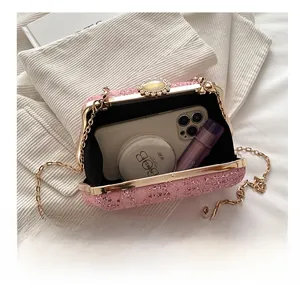 Pink lace evening bag with sequins, jewel clasp and chain, showing interior capacity
