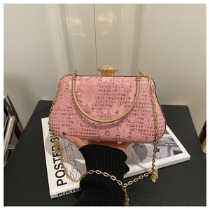 Close-up of pink lace evening bag with sparkling rhinestones and crystal clasp detail
