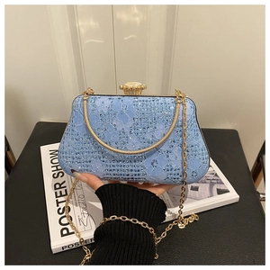 Detail of light blue lace evening bag with rhinestones and vintage metal clasp