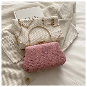 Detail of pink lace and sequin beaded evening clutch with gold metal handle and chain