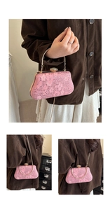 Macro detail of pink lace evening bag featuring sparkling rhinestones and metal handle