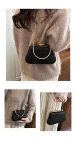 Detail of black sequined evening clutch bag with gold handle and crystal top closure