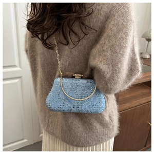 Detail of light blue lace evening bag with sparkling rhinestones and gold chain